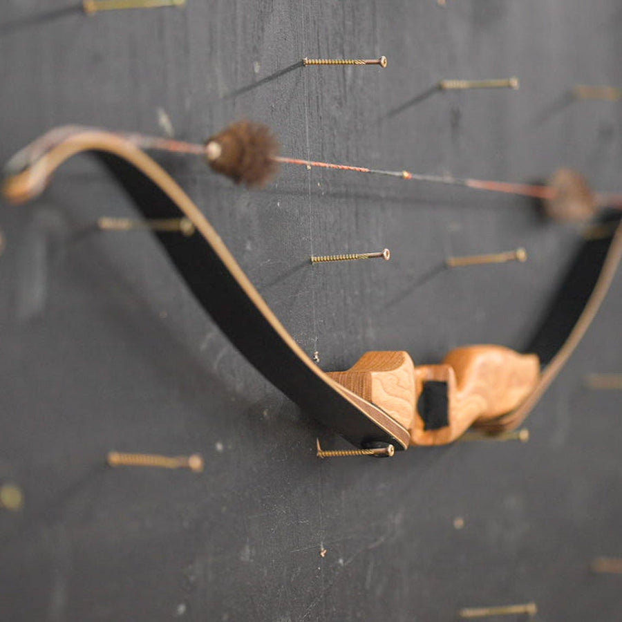 Bob Garner USA-Made Takedown Recurve Bow — Bob Garner bow on workshop wall