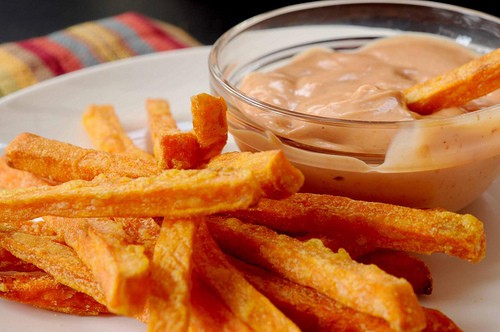 Sweet potato fries served beside creamy Cajun-style dip