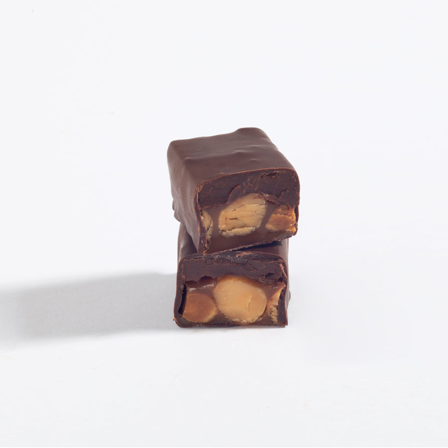 Stacked pieces of Peanut Caramel & Dark Chocolate Ganache Bar