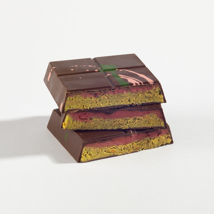 Raspberry Ganache Dubai Pistachio Chocolate Bar cut open to show its layered filling