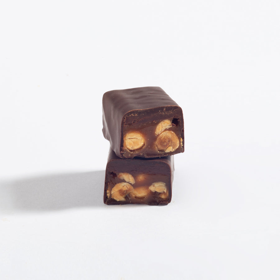 Stacked pieces of Mac Daddy Macadamia Caramel & Dark Chocolate Bar