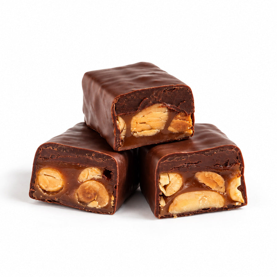 Cut Nostalgia chocolate bars showing nut, caramel, and ganache centers