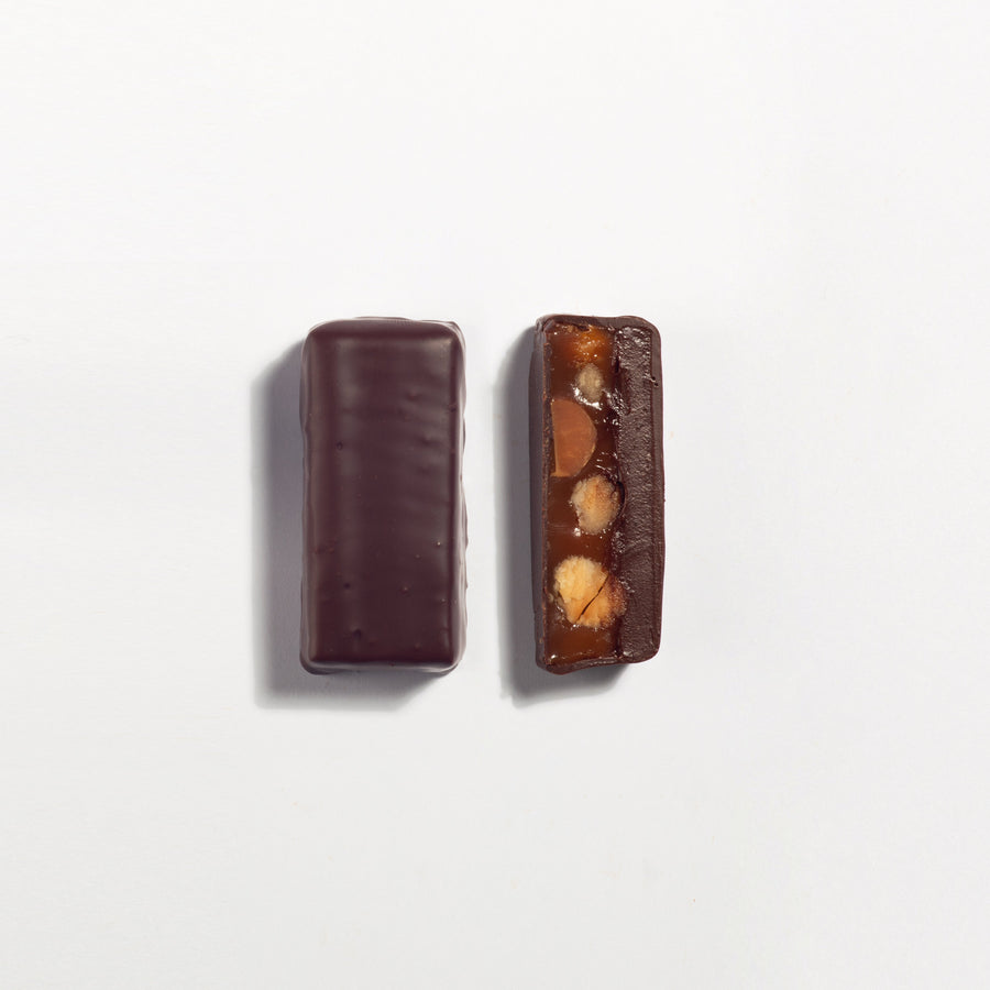 Mac Daddy Macadamia Caramel & Dark Chocolate Bar cut open to show the filling