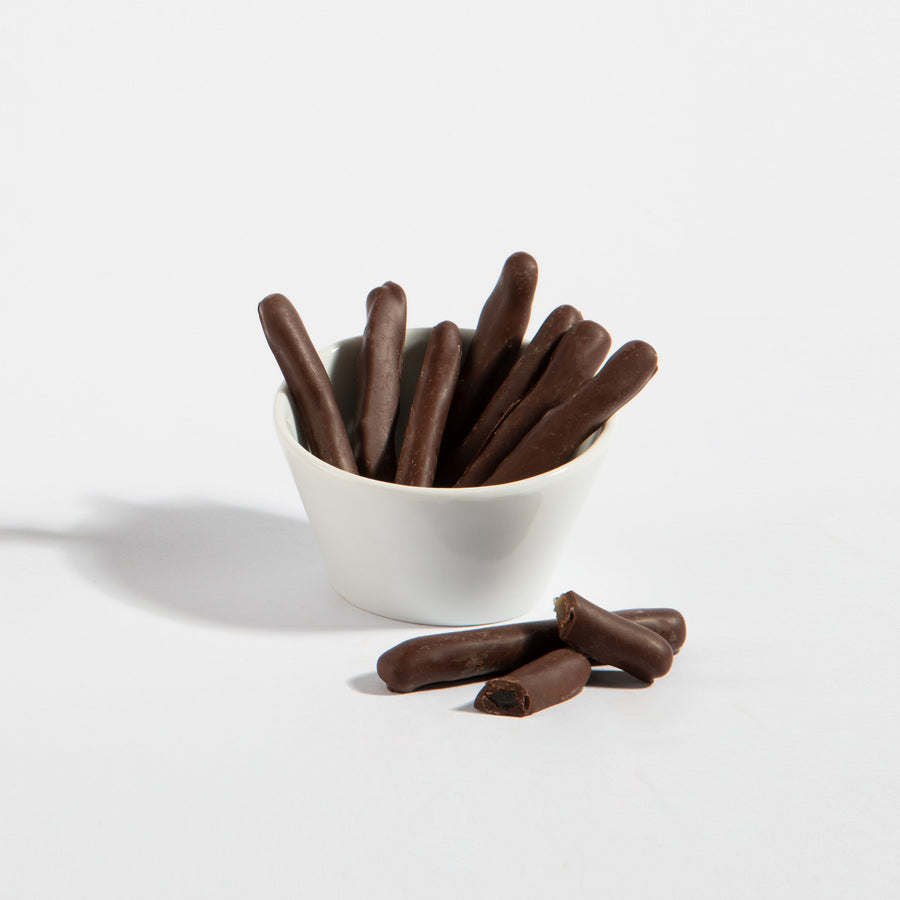 Chocolate-covered lemon peel strips in a white serving bowl
