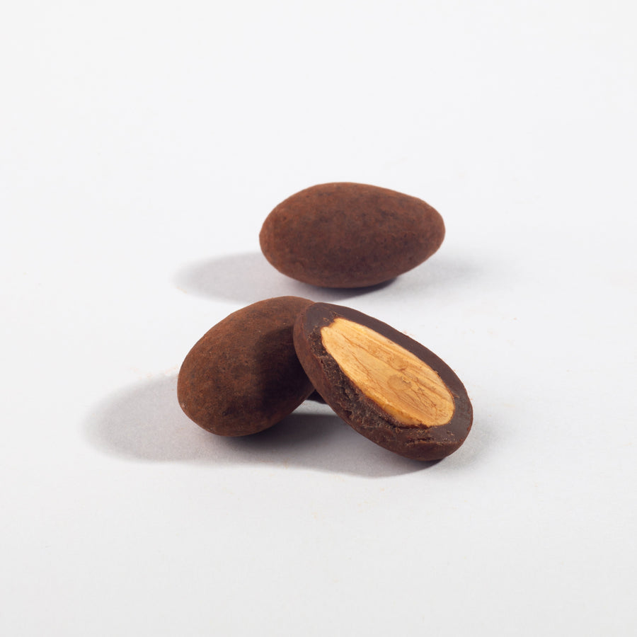 Whole and halved Triple Chocolate Almonds showing the almond center