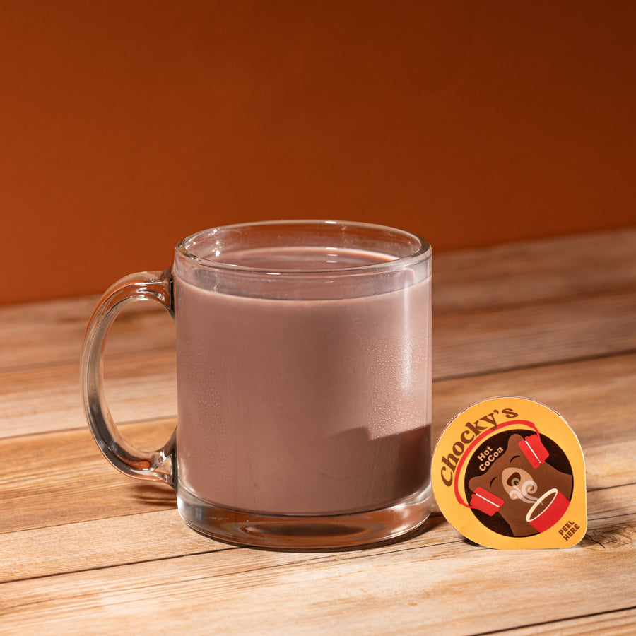 Hot cocoa in a glass mug with pod