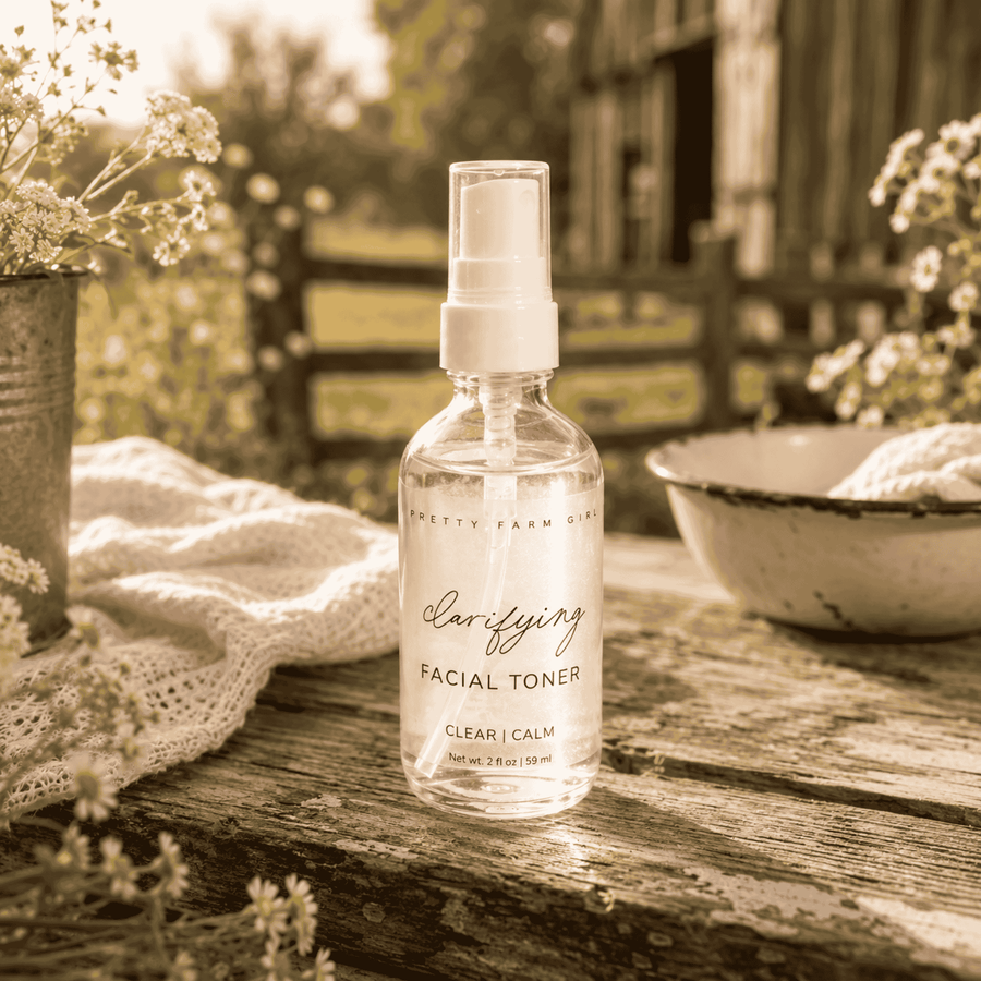 Clarifying Toner bottle beside dried flowers