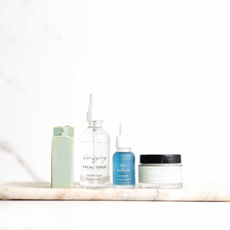 Four Clear and Calm skincare products on a white shelf
