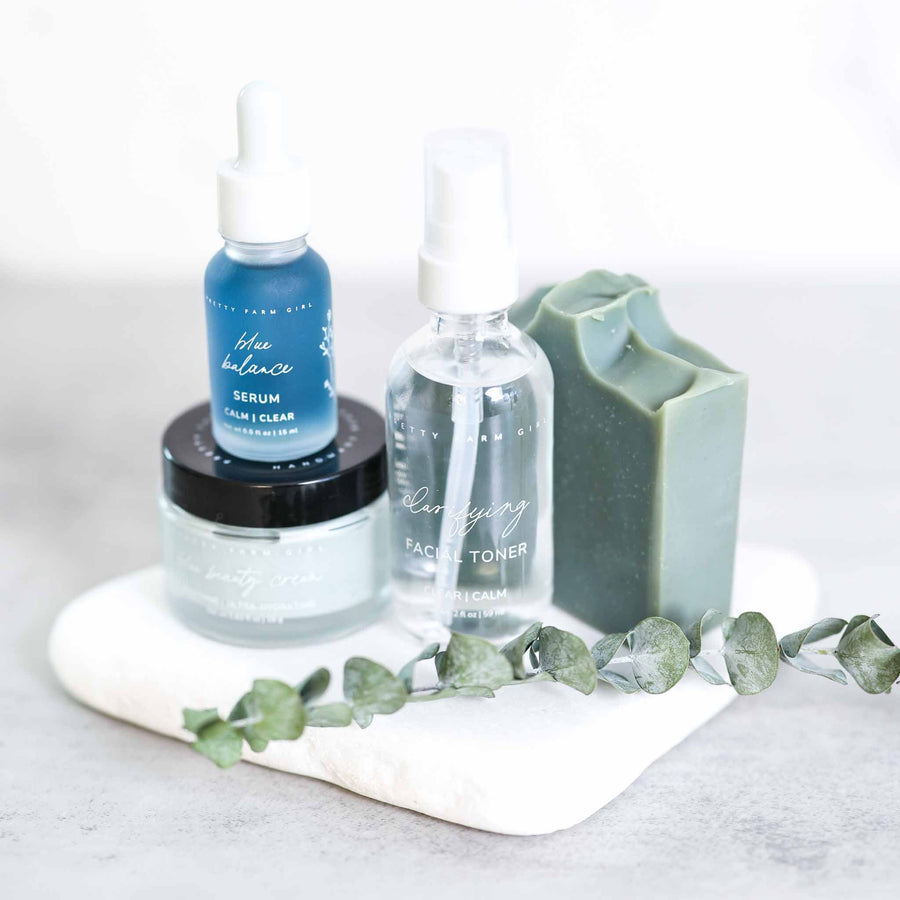 Clear and Calm kit products on a white tray with foliage