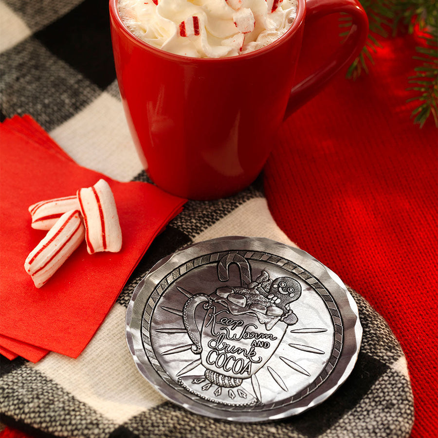 Styled display featuring Keep Warm and Drink Cocoa Coaster