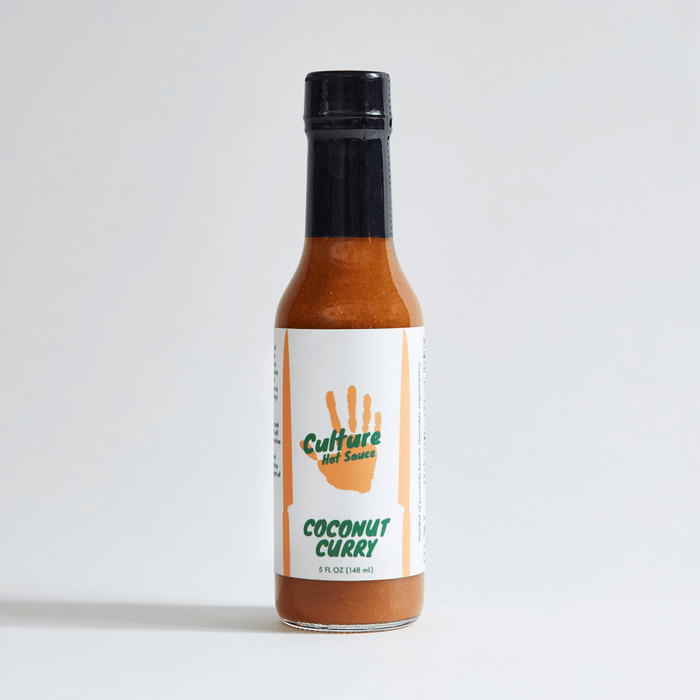 Coconut Curry hot sauce bottle with an orange sauce and green hand logo