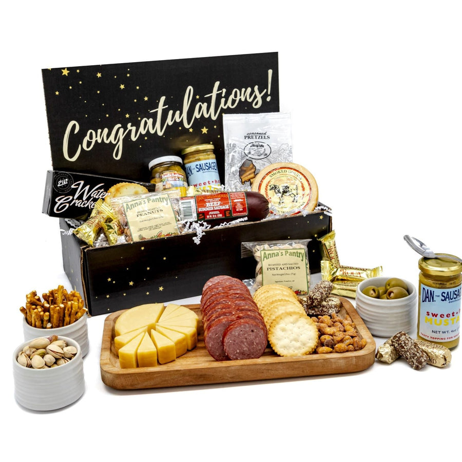 Congratulations gift box with sausage, cheese, crackers, mustard, olives, nuts and candy; serving display