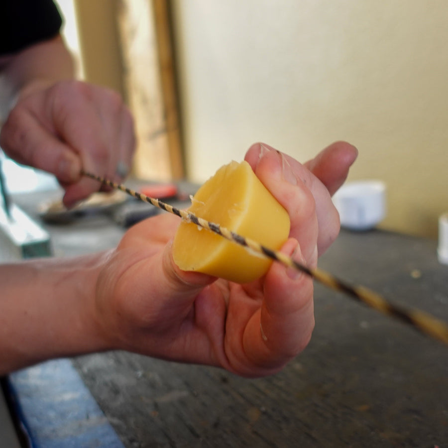 Perfect Bowstring Maker’s Wax — wax held against bowstring strands
