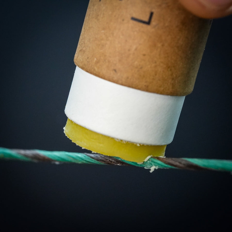 Sticky Perfect Bowstring Wax — close-up of wax contacting string