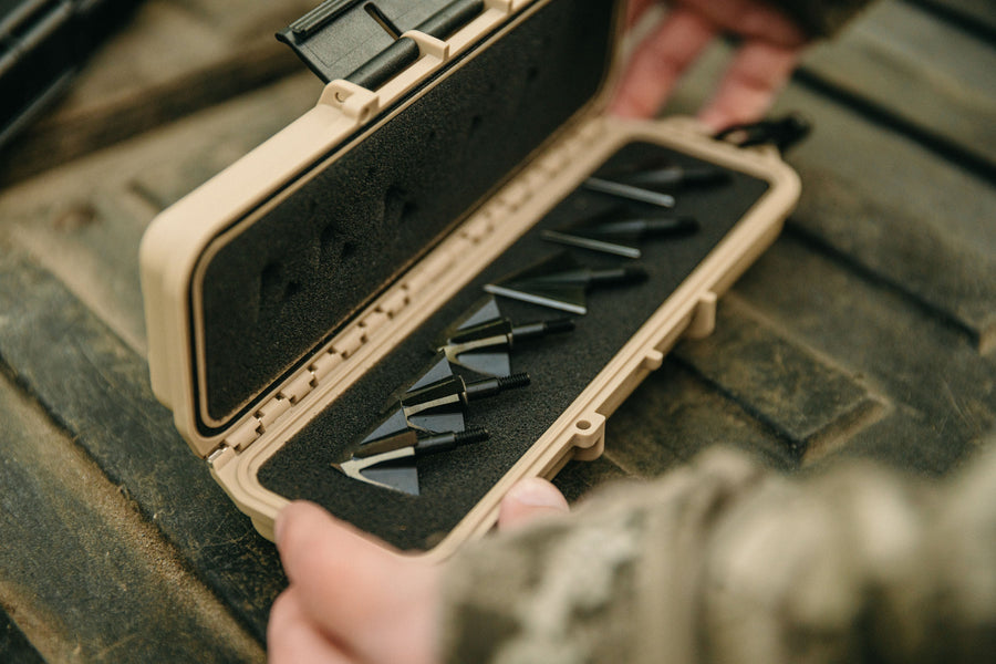 Close view of broadheads organized in a tan case