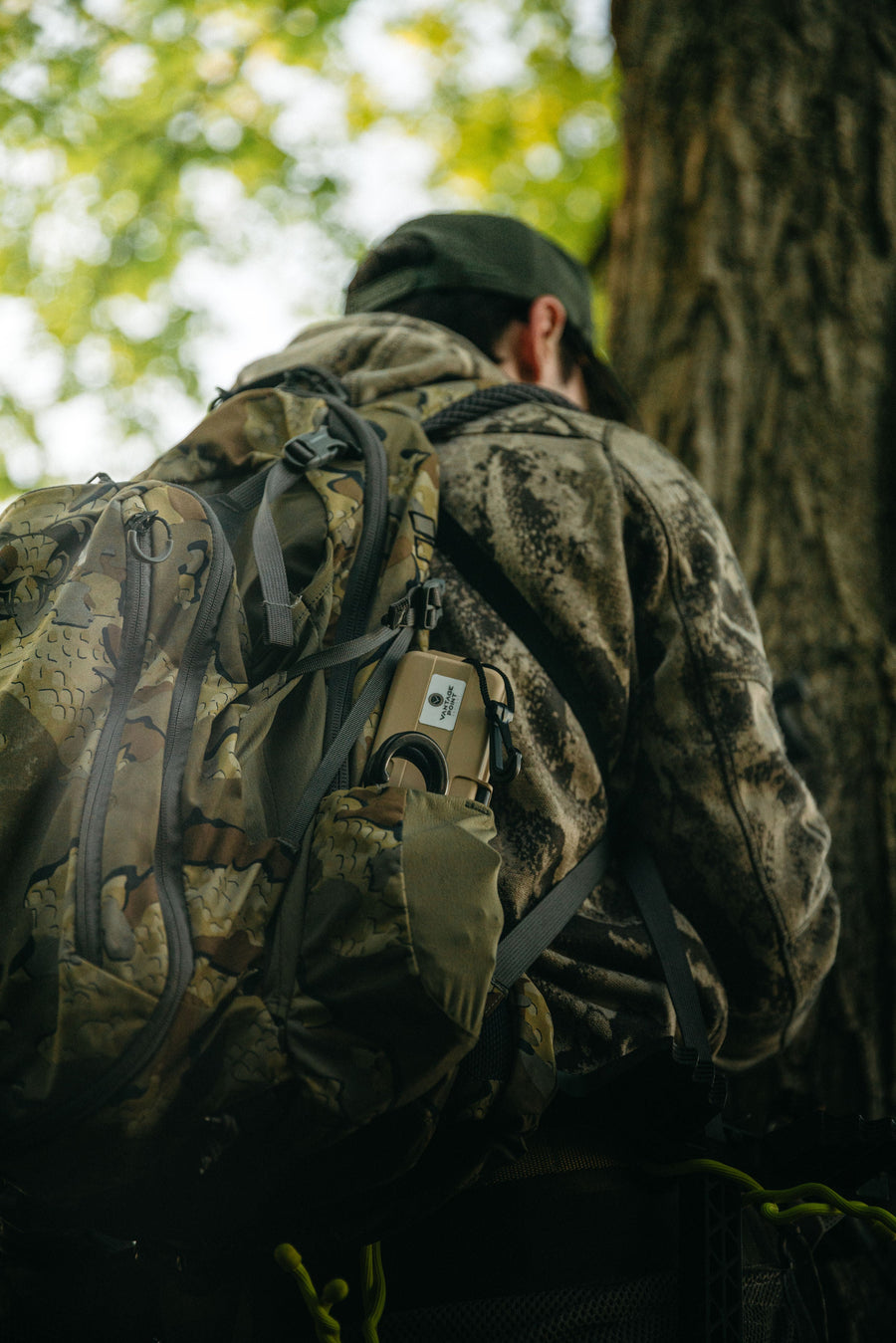 Bowhunter wearing a backpack in the woods