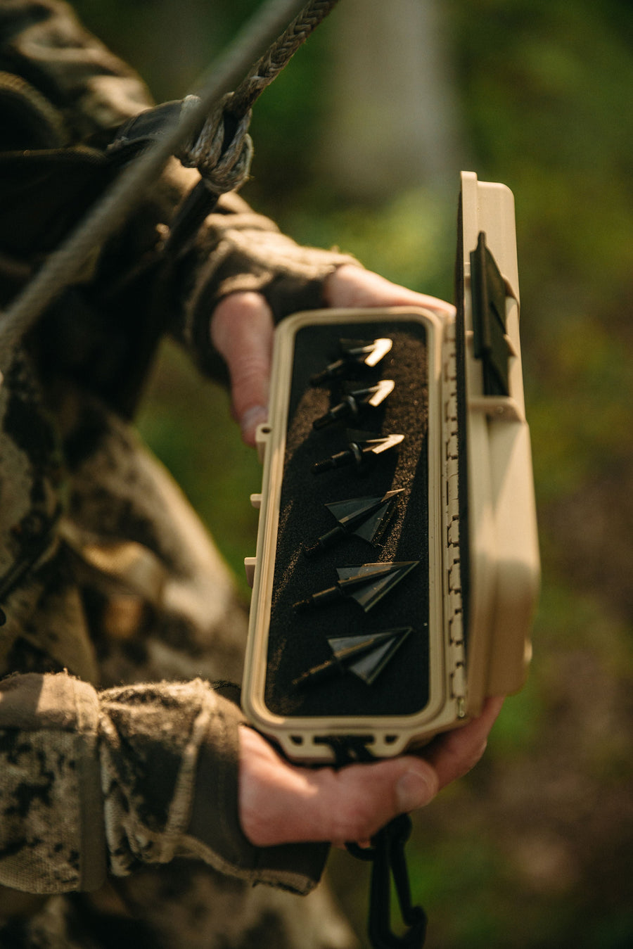 Tan case held open to show the broadhead layout