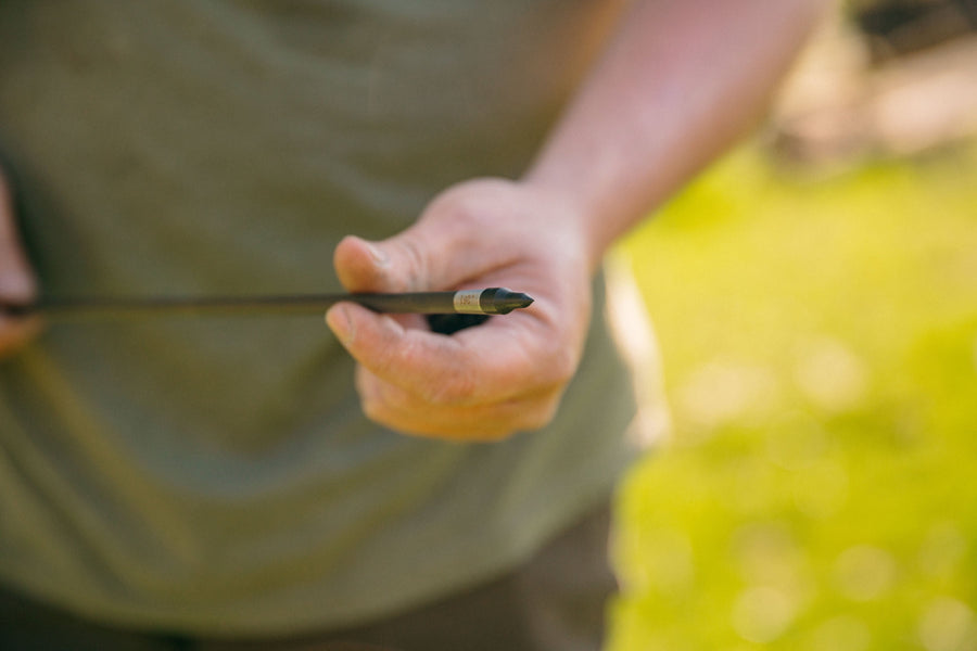 Practice arrow with a field point being held outdoors