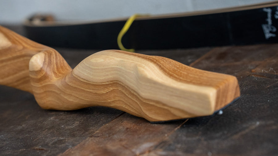 Bob Garner USA-Made Takedown Recurve Bow — hickory riser laid on workbench