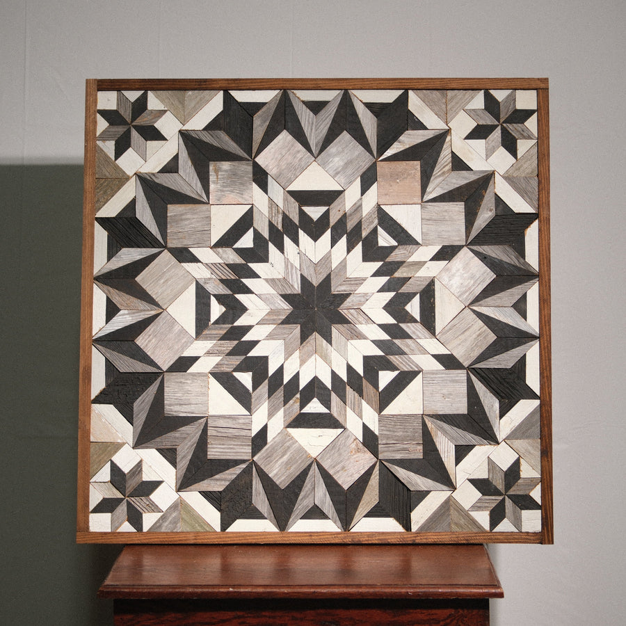 Individual reclaimed-wood barn quilt with a hand-painted geometric star design