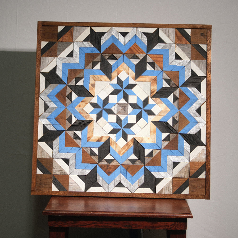 Individual reclaimed-wood barn quilt with a hand-painted geometric star design