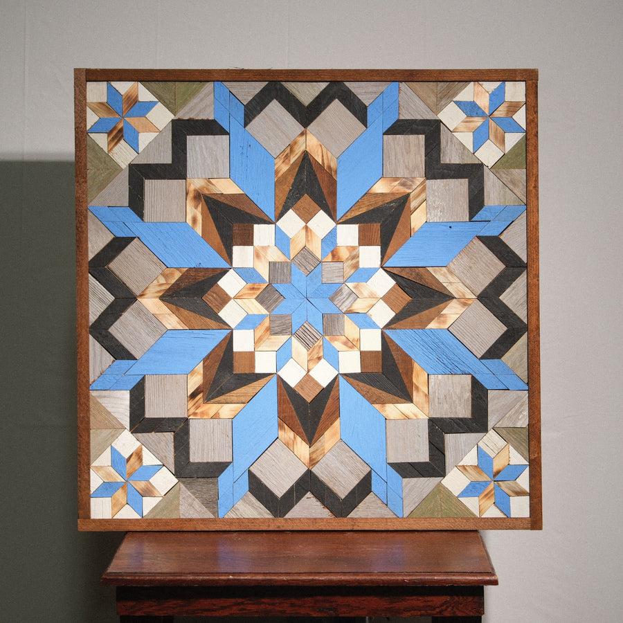 Individual reclaimed-wood barn quilt with a hand-painted geometric star design