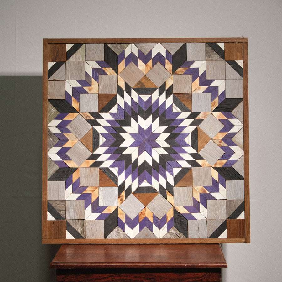 Individual reclaimed-wood barn quilt with a hand-painted geometric star design