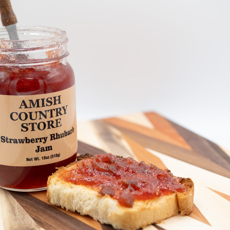 Strawberry Rhubarb Jam package with serving suggestions in a styled food scene