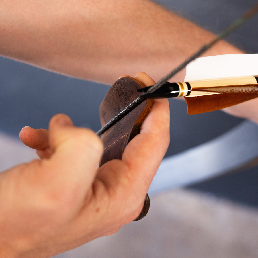 YES Tab 3-Under Archery Finger Tab — three-under grip demonstrated with tab