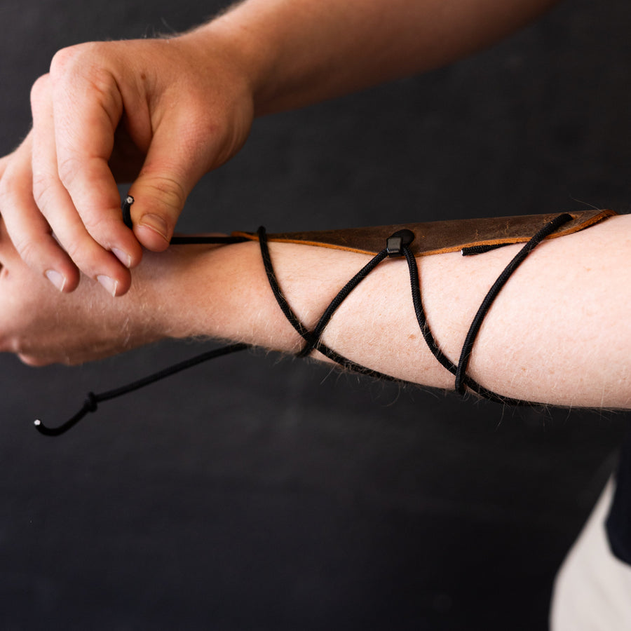 Essential Leather Archery Arm Guard — hand fastening arm-guard cords