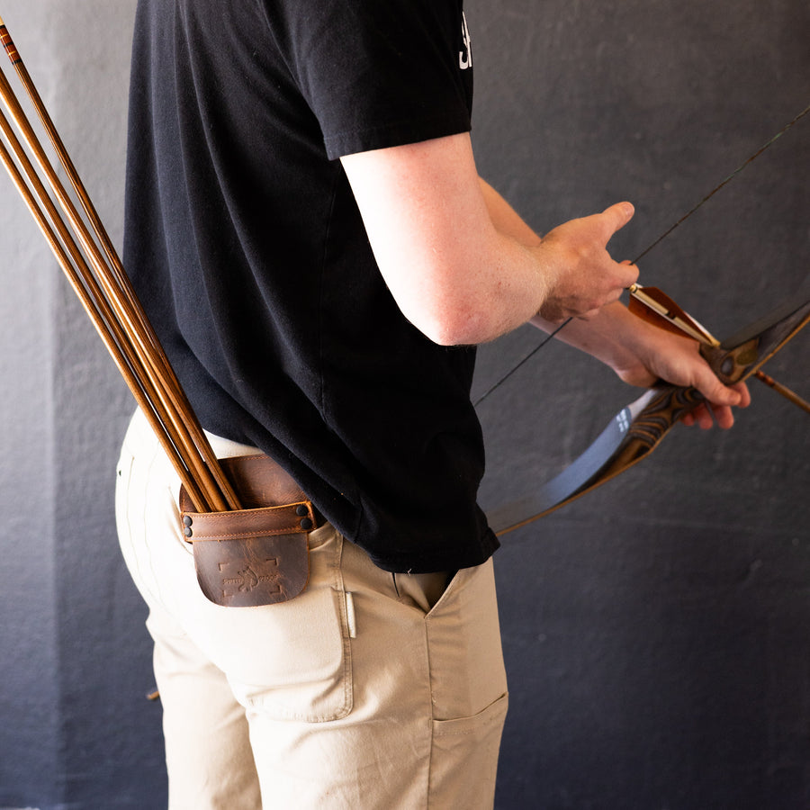 Leather Pocket Arrow Quiver — archer reaching for arrows in pocket quiver