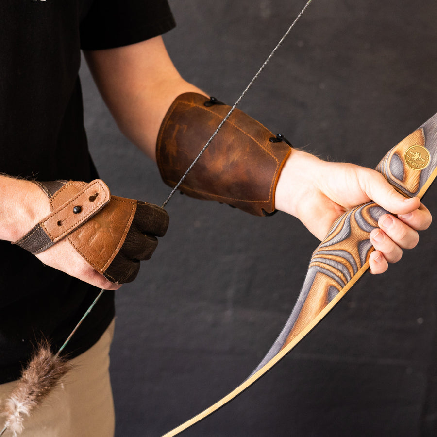 BONES Reflex-Deflex Longbow — leather armguard and bow grip in use