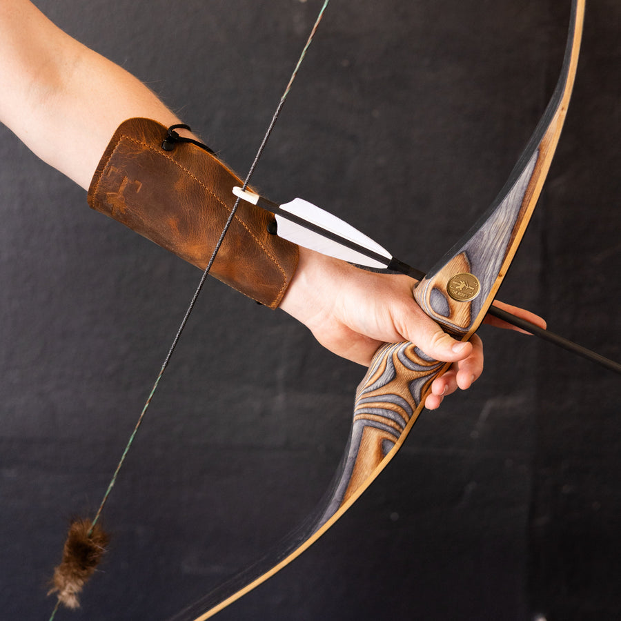 BONES Reflex-Deflex Longbow — archer preparing a shot