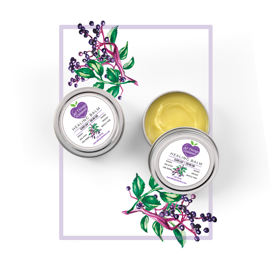 Elderleaf botanical skin balm tins with one open tin showing golden balm