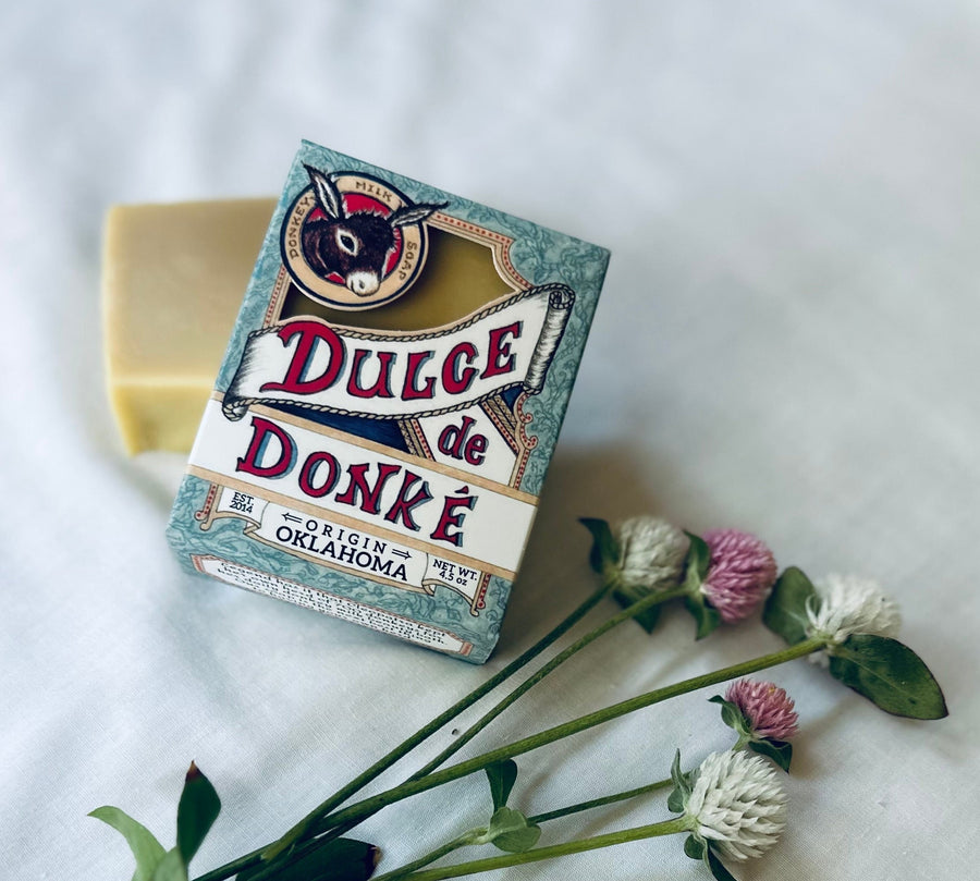 Unscented soap and its box beside clover flowers