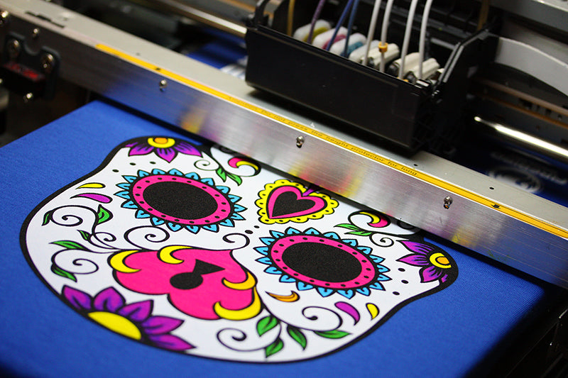 Colorful skull artwork being printed on a DTG printer
