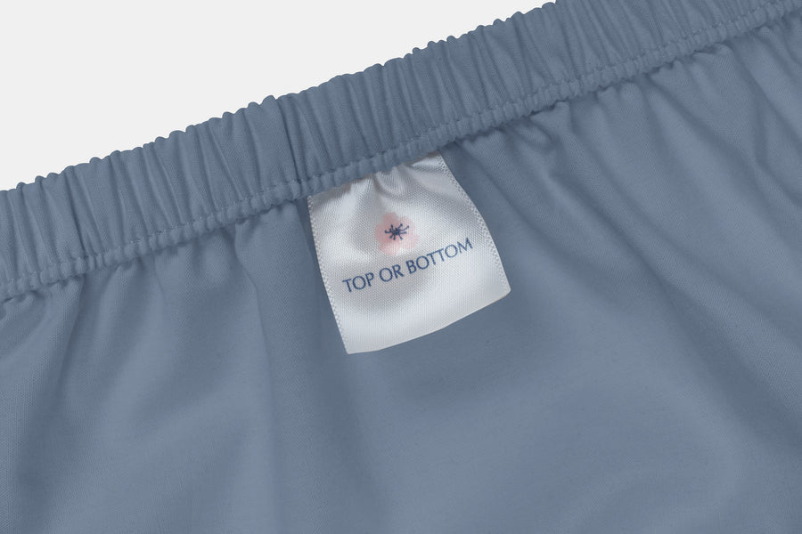Top or Bottom label on blue fitted-sheet elastic