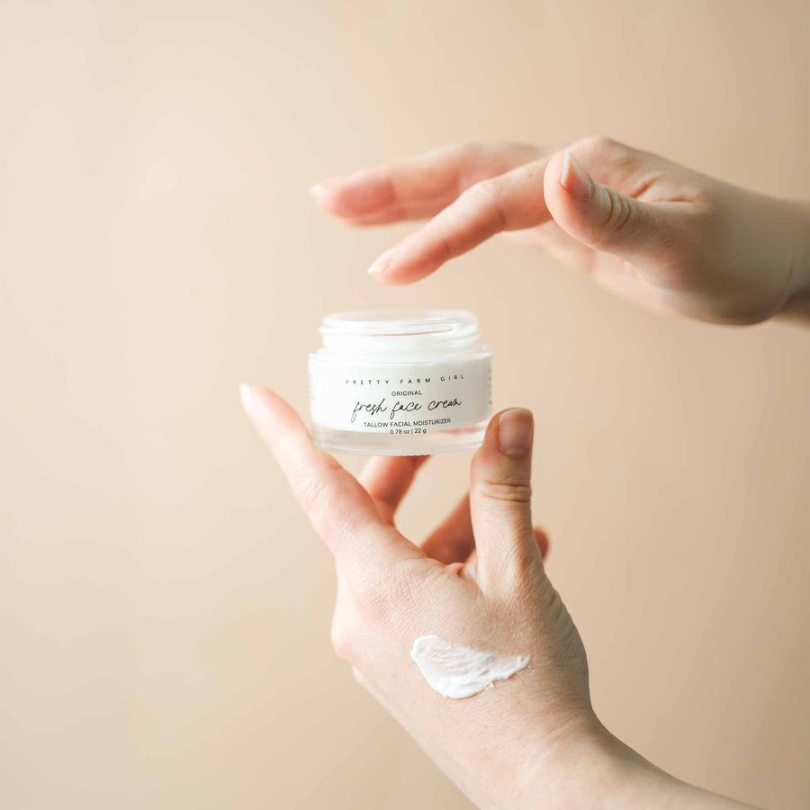 Person holding Fresh Face cream jar