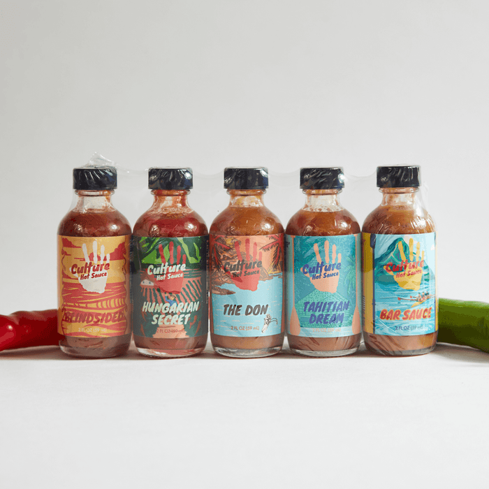 Five small hot sauce bottles: Blindsided, Hungarian Secret, The Don, Tahitian Dream and Bar Sauce