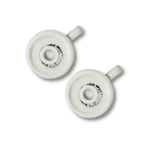 Undersides of the stoneware salt and pepper shakers showing removable fill stoppers