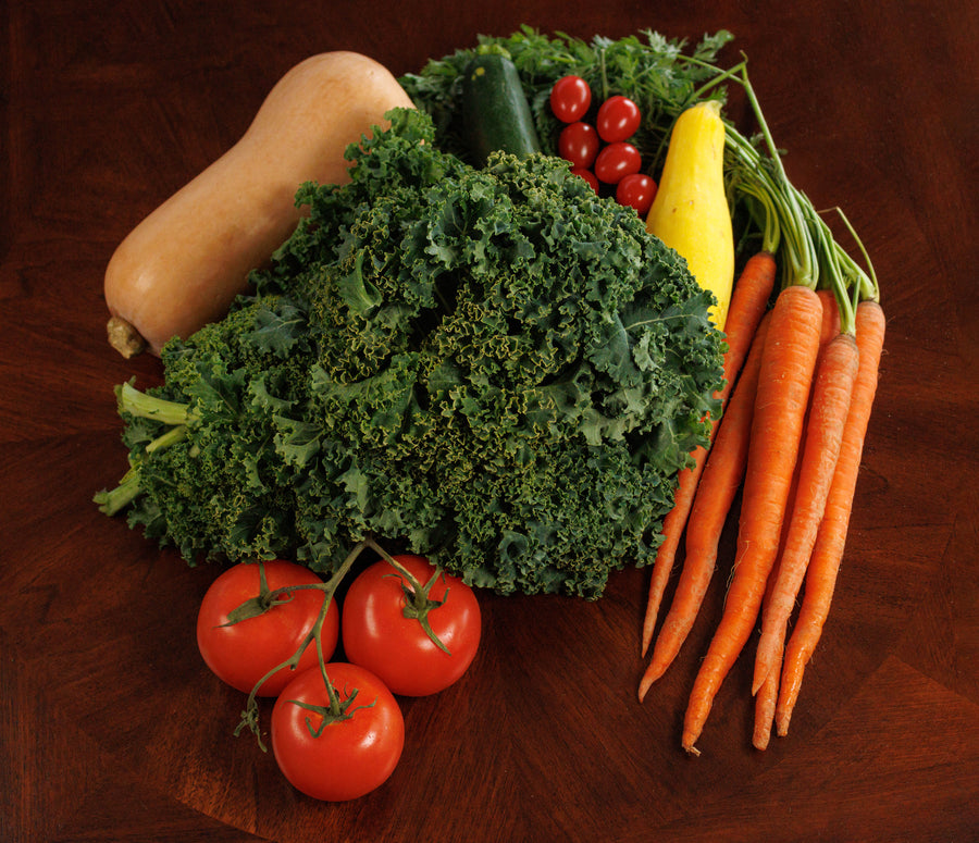 Basket of fresh vegetables illustrating possible garden crops