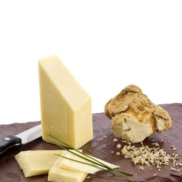 Horseradish cheddar wedge beside horseradish root
