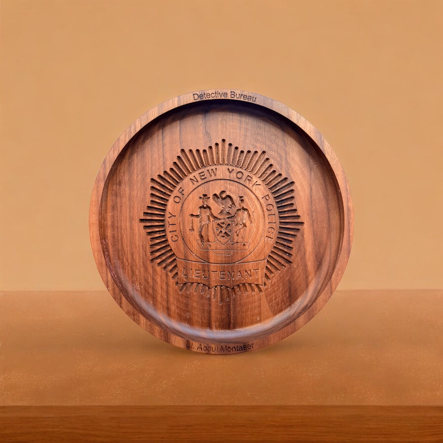 Round wooden tray displayed upright with an engraved seal