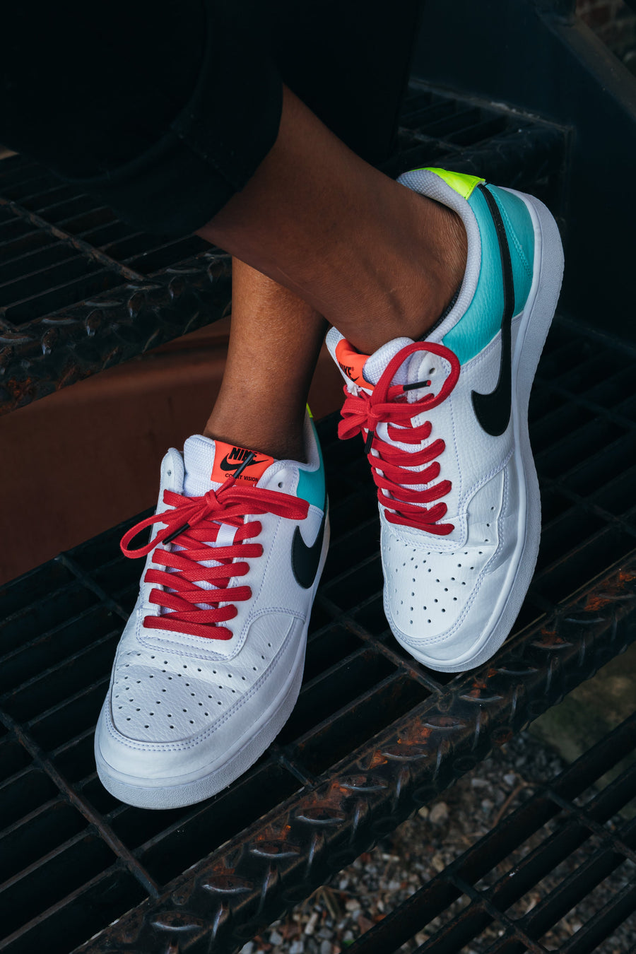 Red glazed cotton shoelaces worn with white sneakers on steps