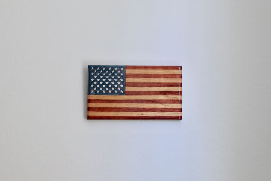 Young Glory American flag hanging on an indoor wall