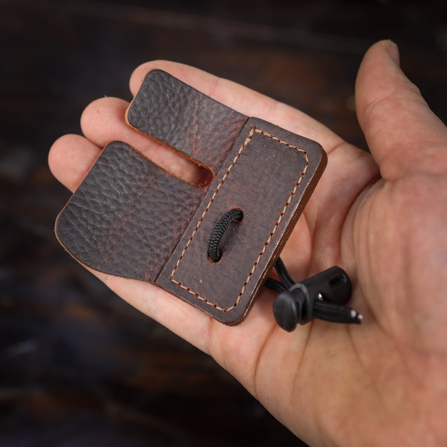 Split-Finger Leather Archery Tab — fitted tab in archer's hand