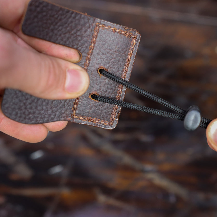 Split-Finger Leather Archery Tab — shock cord and cord-lock detail