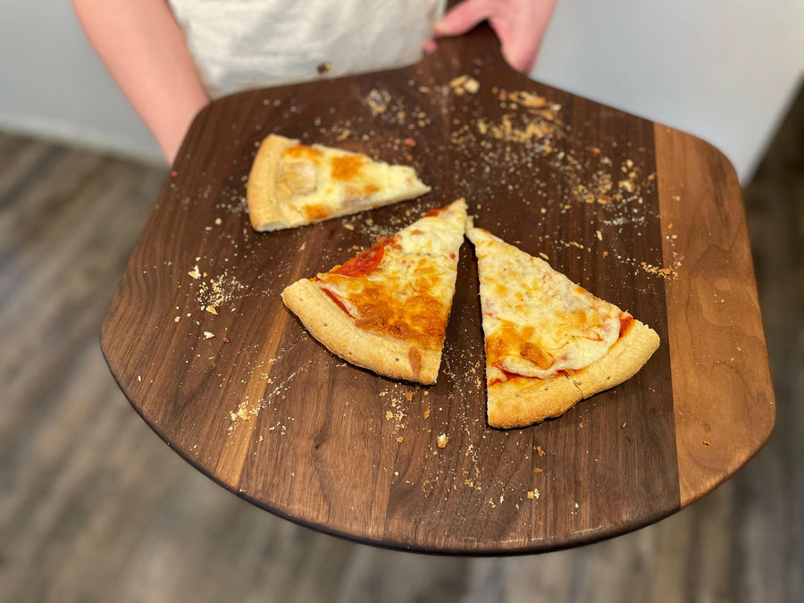 Pizza slices arranged on a wooden pizza peel