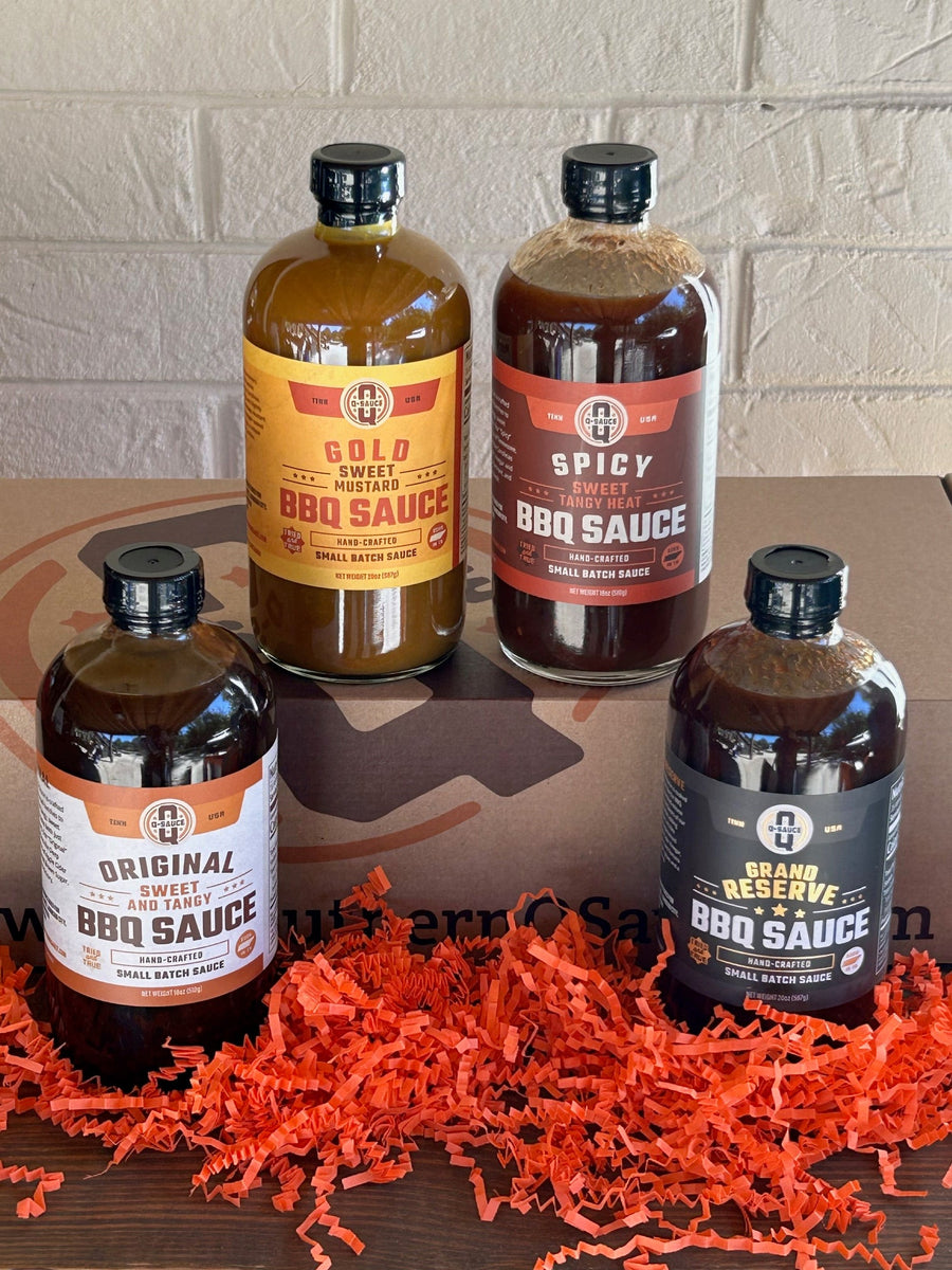 Four Whole Hog barbecue sauce bottles displayed around the gift box