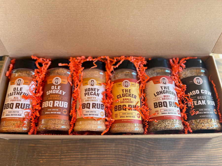 Grill Master gift box open with six rub bottles and orange packing paper